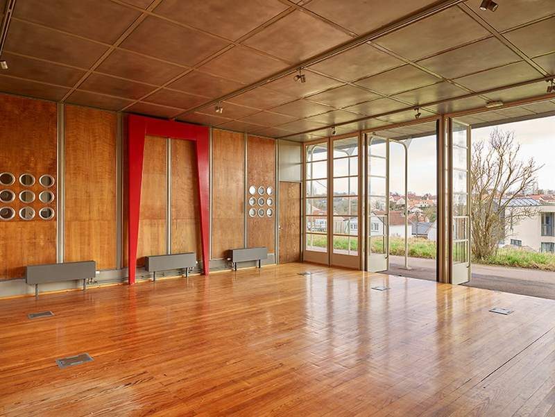 The room, its doors open to the landscape
