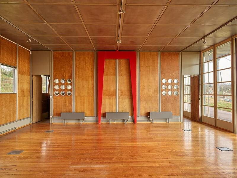 The room and its red portal frame, plywood and portholes